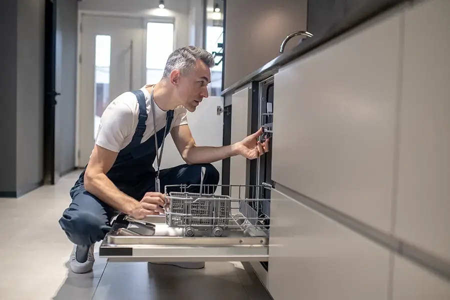 Best appliance repair near me technician fixing kitchen appliance