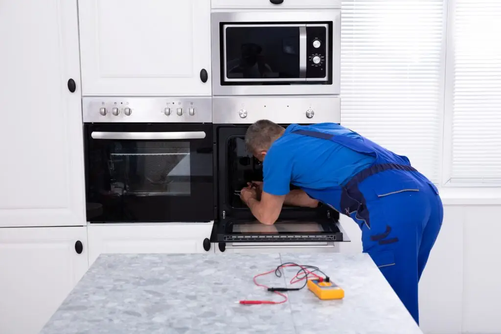 Professional appliance repair technician servicing a home appliance in Toronto