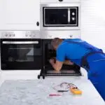 Professional appliance repair technician servicing a home appliance in Toronto