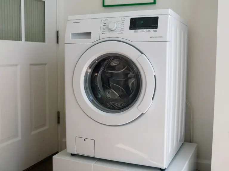 A white front-load washing machine in a bright Toronto laundry room